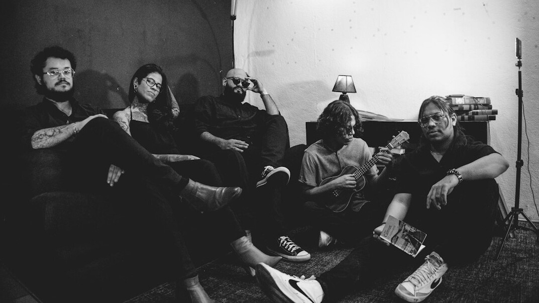 Friends sitting together and talking on a sofa